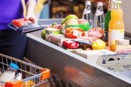 Woman checking groceries out - Find cheap groceries and eggs