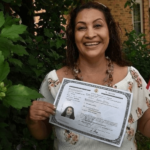 Woman holding naturalization certificate -Study resources for citizenship exam